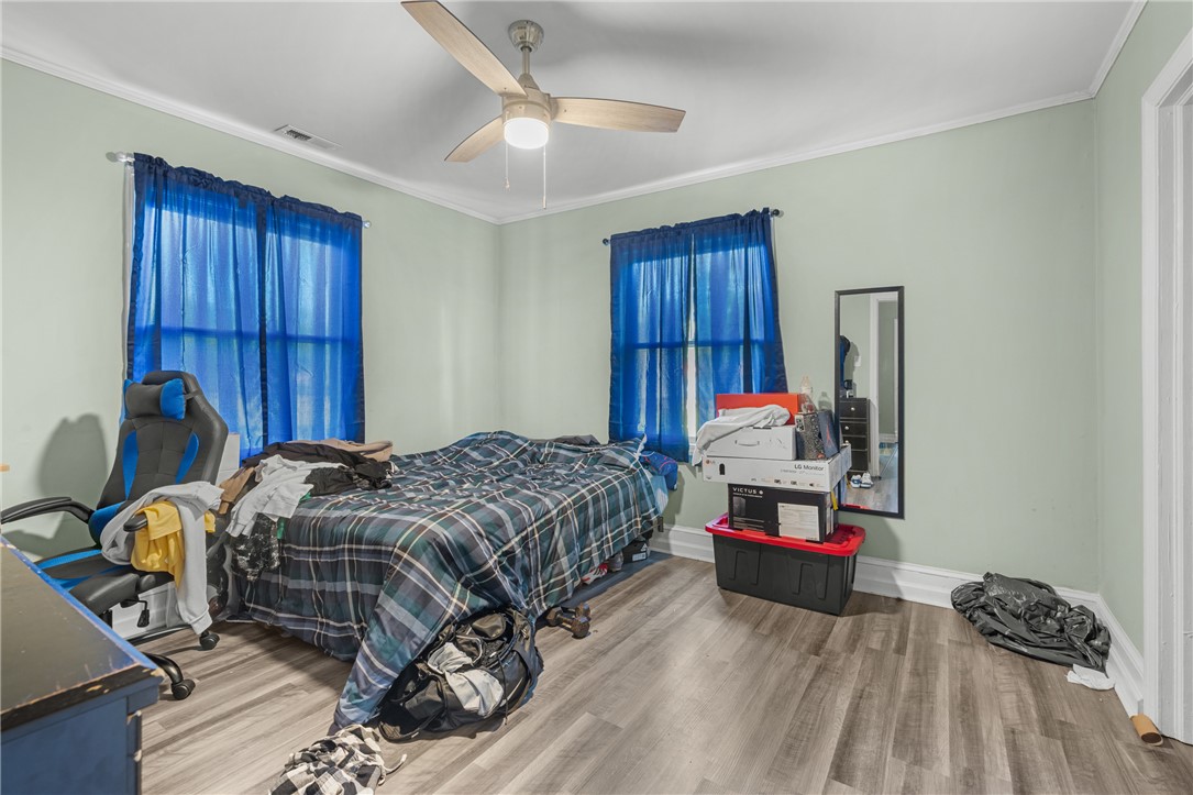 303 South Elm Street Pendleton, SC 29670 - Photo 9 of 16 This spacious bedroom offers comfortable living with elegant crown molding and durable flooring.