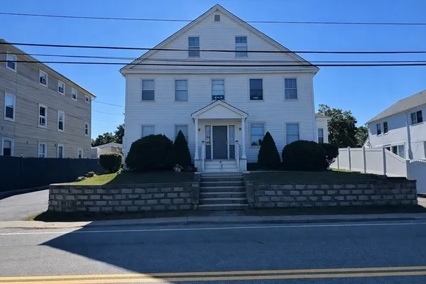 a front view of a house with lots of windows