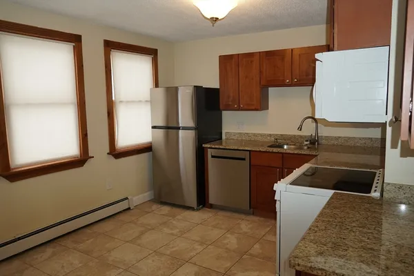 a kitchen with a refrigerator sink and stove