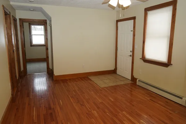 wooden floor in an empty room with a mirror