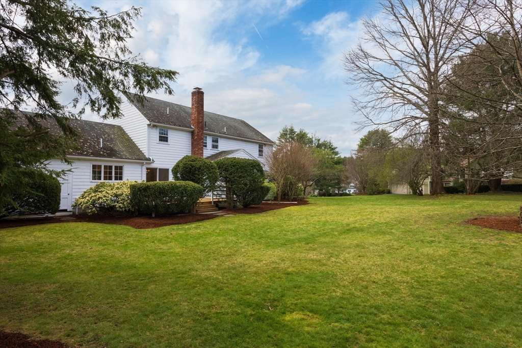 169 Fox Hill Road Needham, MA 02492 - Photo 13 of 22 a view of a house next to a big yard and large trees