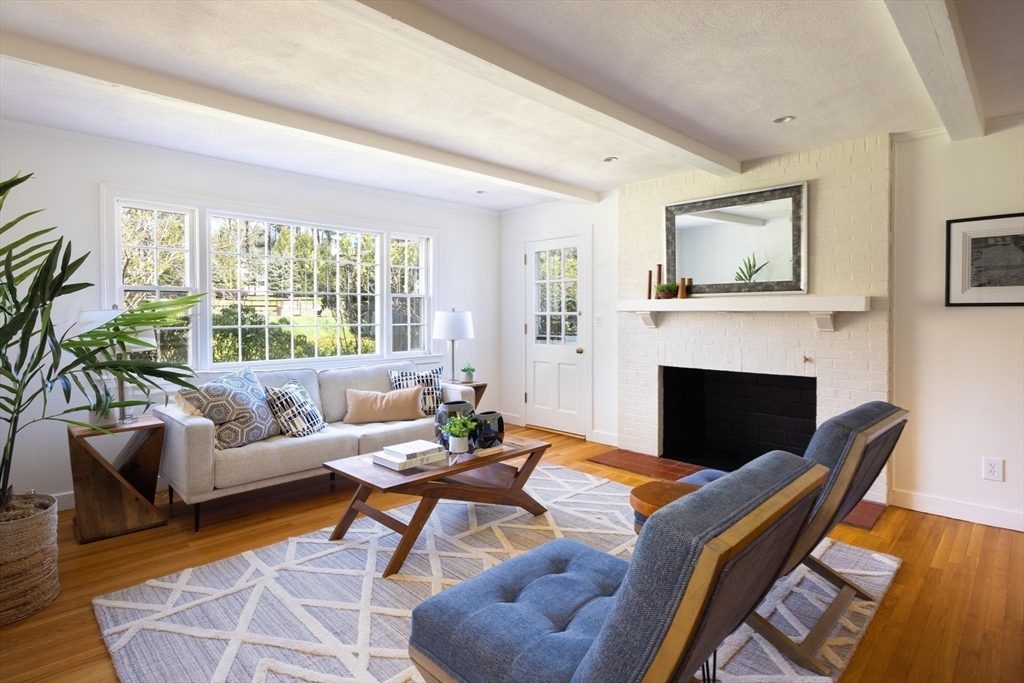 169 Fox Hill Road Needham, MA 02492 - Photo 8 of 22 a living room with furniture a fireplace and a large window