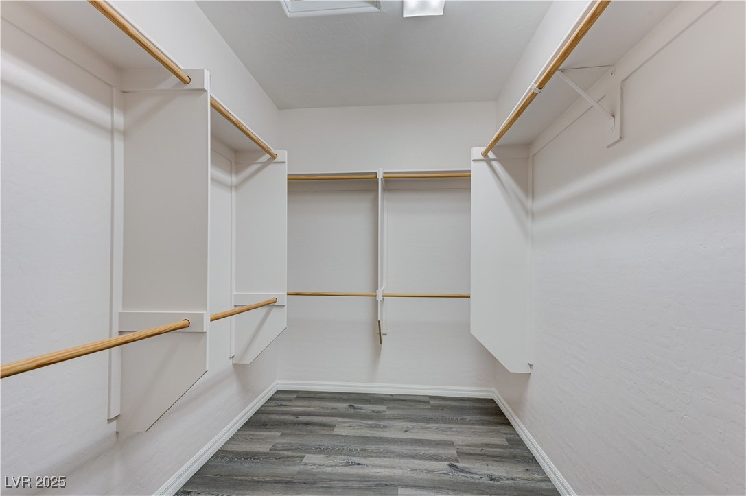 6946 Motley Road Las Vegas, NV 89178 - Photo 17 of 31 Spacious closet in Primary Bedroom, featuring wood finished floors