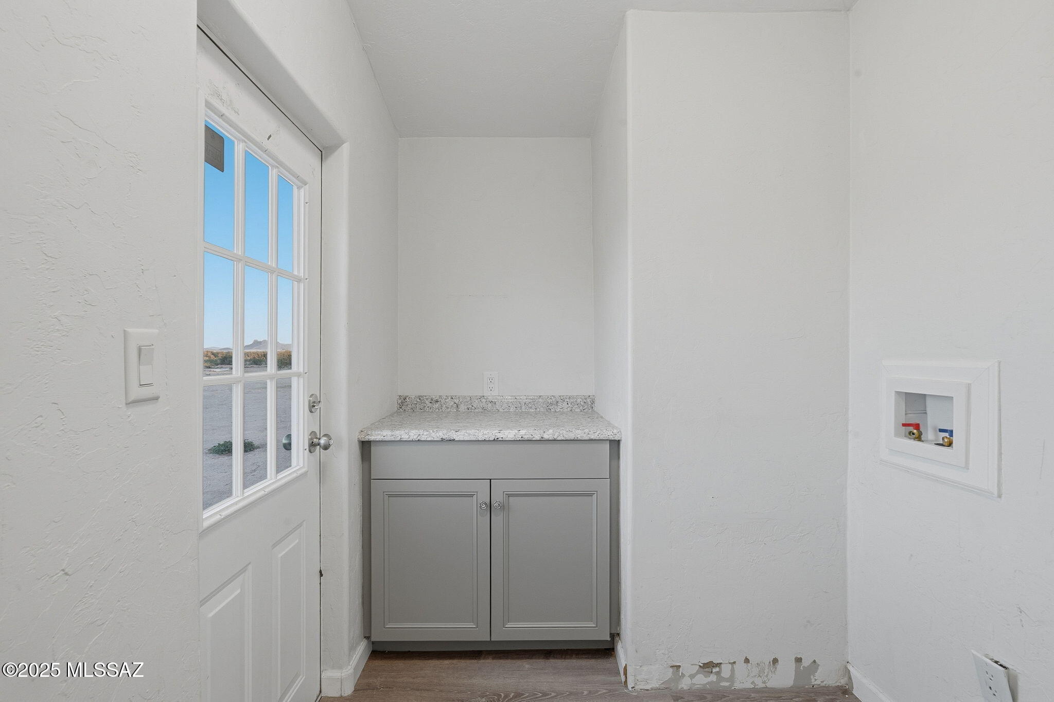 9740 North Running Back Way Marana, AZ 85653 - Photo 24 of 34 Laundry room w/ folding table & storage.