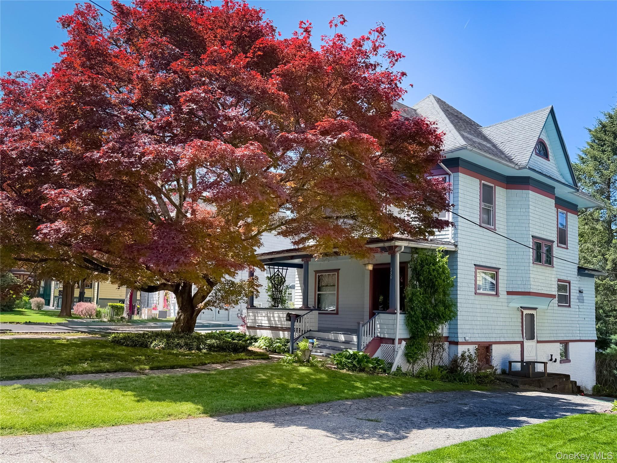 350 Smith Street Peekskill, NY 10566 - Photo 1 of 32 a front view of a house with a garden and tree