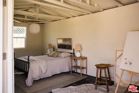 a bedroom with a bed a desk and chair
