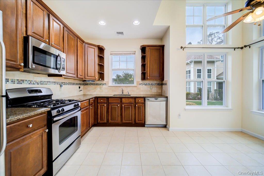 26 Halley Court Poughkeepsie, NY 12601 - Photo 11 of 47 a kitchen with stainless steel appliances granite countertop a stove top oven a sink dishwasher and a microwave oven on the blue kitchen countertops