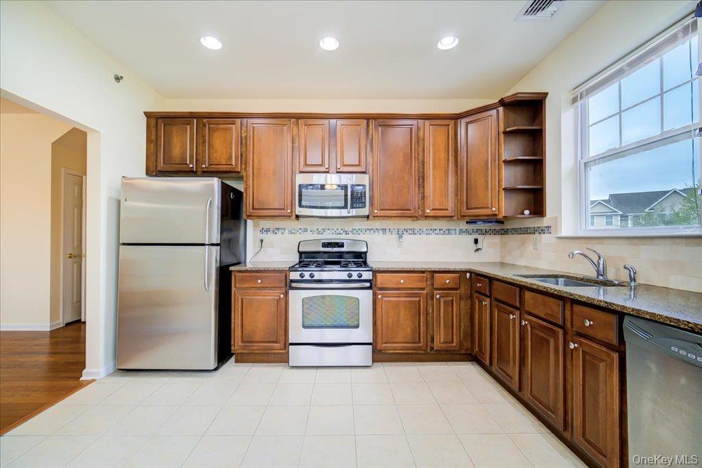 26 Halley Court Poughkeepsie, NY 12601 - Photo 12 of 47 a kitchen with stainless steel appliances granite countertop a refrigerator stove a sink and dishwasher