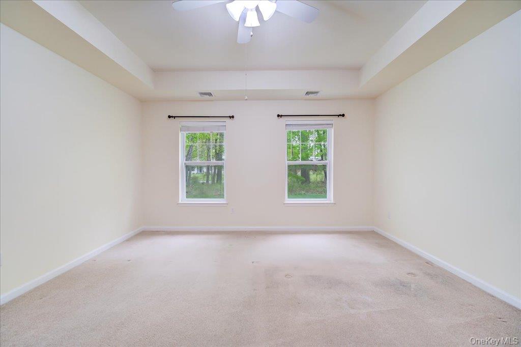 26 Halley Court Poughkeepsie, NY 12601 - Photo 16 of 47 an empty room with windows and chandelier fan