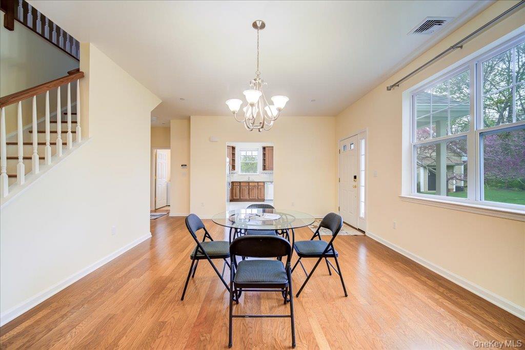 26 Halley Court Poughkeepsie, NY 12601 - Photo 8 of 47 a dining room with furniture a chandelier and wooden floor