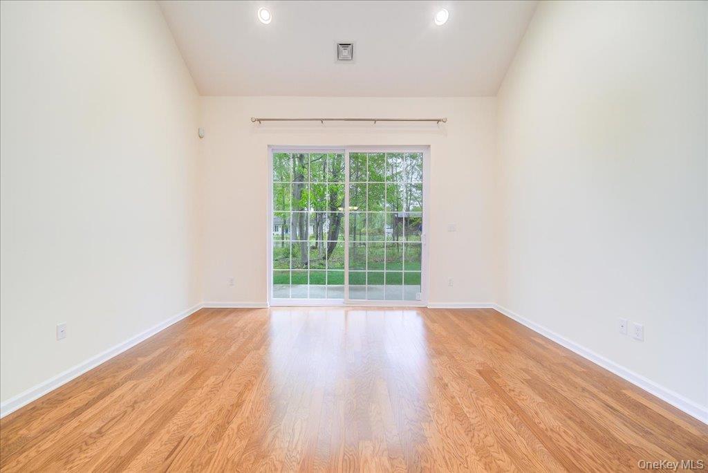 26 Halley Court Poughkeepsie, NY 12601 - Photo 9 of 47 a view of an empty room with wooden floor and a window