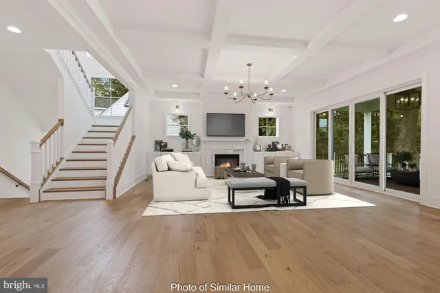 a living room with furniture a fireplace and a chandelier