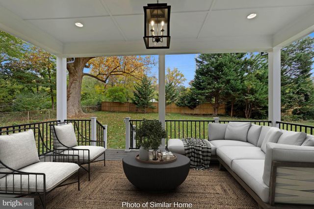 a living room with patio furniture and a potted plant