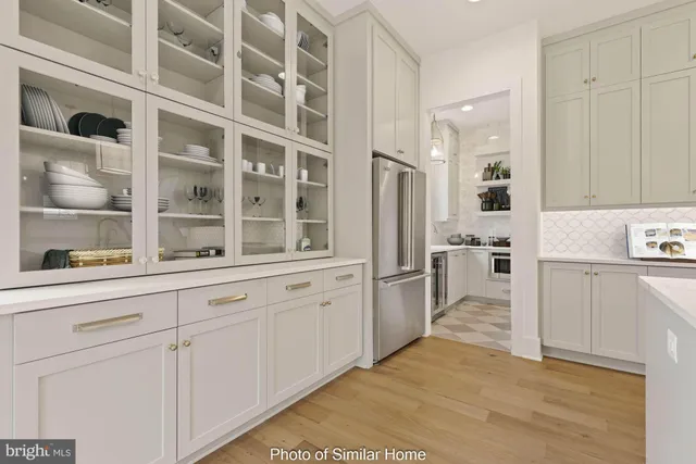 a kitchen with granite countertop cabinets and refrigerator