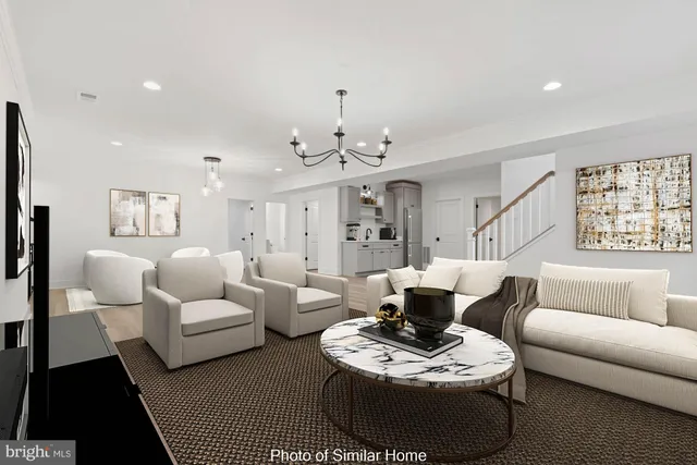 a living room with furniture and a chandelier