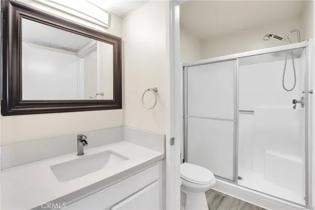 a bathroom with a sink vanity mirror and toilet