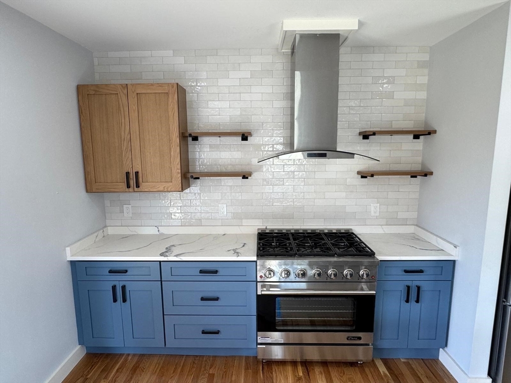 41 Westminster Street Worcester, MA 01605 - Photo 12 of 36 a kitchen with granite countertop cabinets and stove top oven