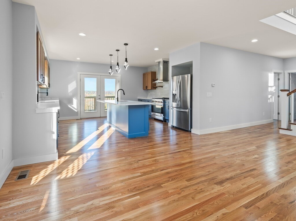 41 Westminster Street Worcester, MA 01605 - Photo 8 of 36 a kitchen with stainless steel appliances kitchen island granite countertop a refrigerator and a stove top oven