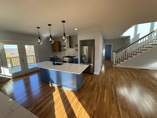 a living room with dining room and wooden floor