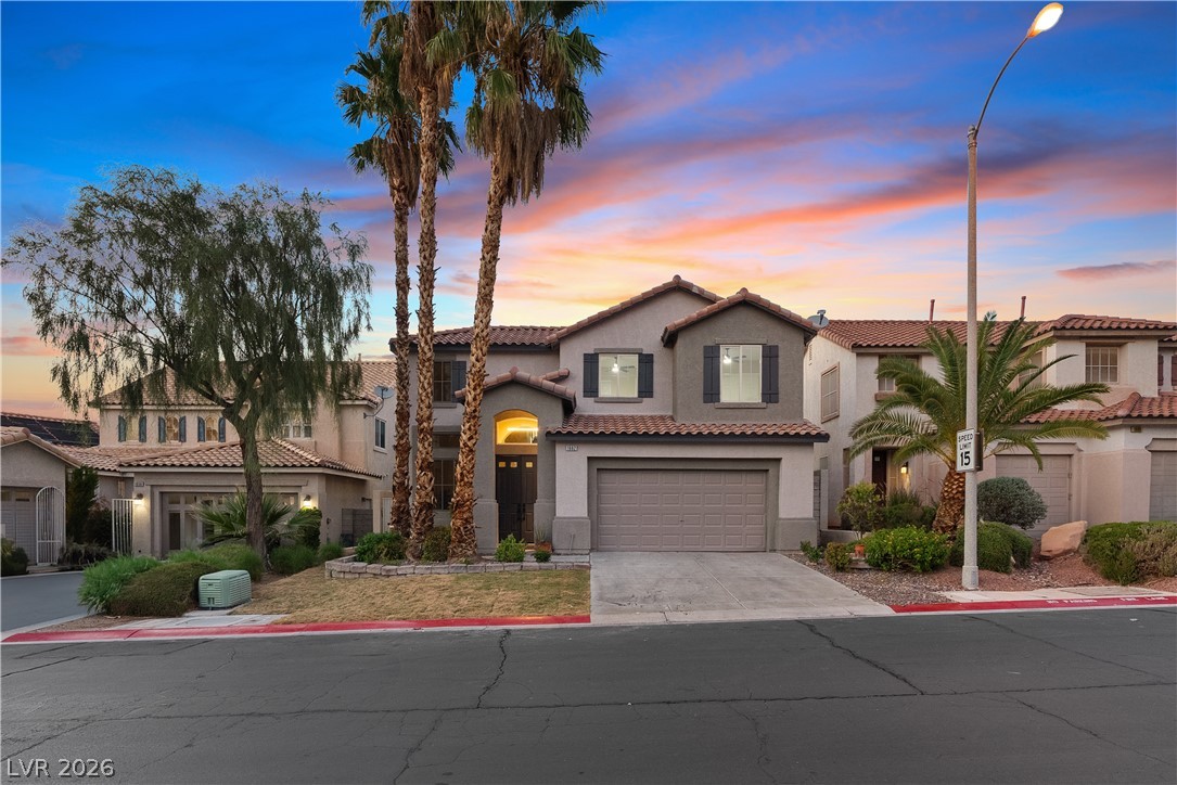 1662 Ravanusa Drive Henderson, NV 89052 - Photo 4 of 74 Showcasing beautiful Mediterranean architecture, this residence features a tile roof, stucco exterior, and attached garage.