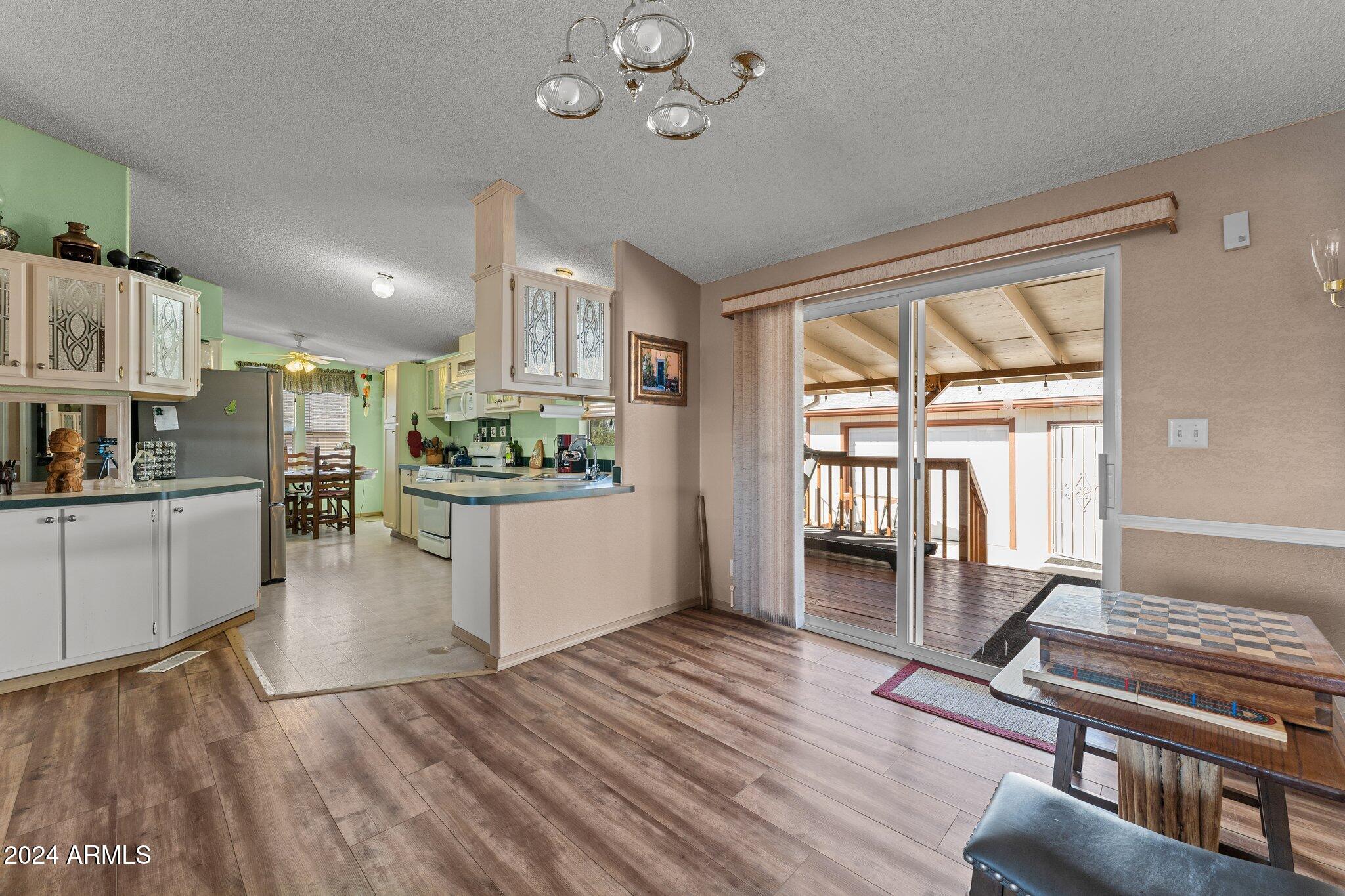 30854 Wandering Way Congress, AZ 85332 - Photo 15 of 43 a kitchen with stainless steel appliances granite countertop a stove and refrigerator