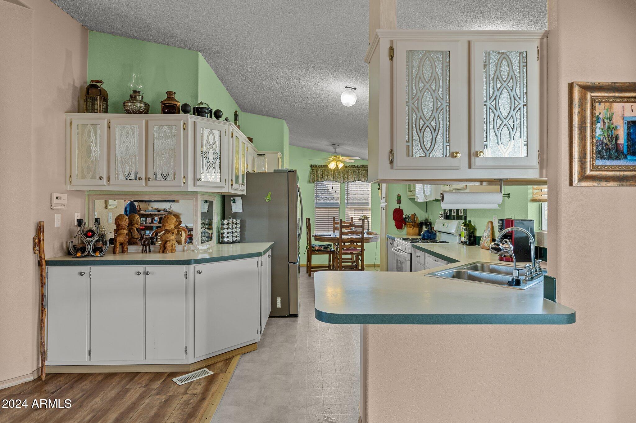 30854 Wandering Way Congress, AZ 85332 - Photo 16 of 43 a kitchen with stainless steel appliances granite countertop a sink and cabinets