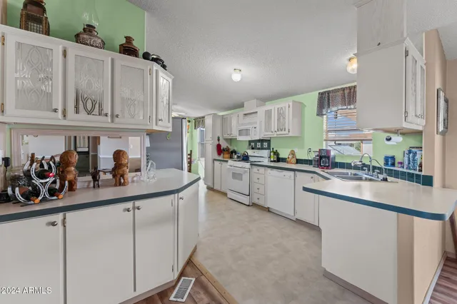 a kitchen with white cabinets and white appliances