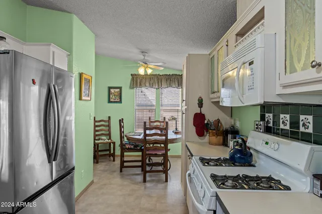 a kitchen with stainless steel appliances granite countertop a stove and a refrigerator