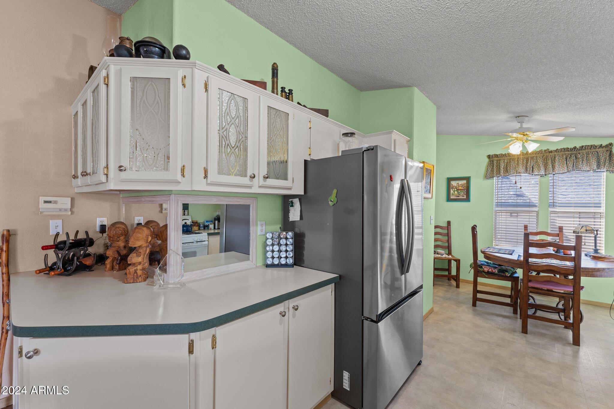 30854 Wandering Way Congress, AZ 85332 - Photo 20 of 43 a kitchen with stainless steel appliances a refrigerator and a sink
