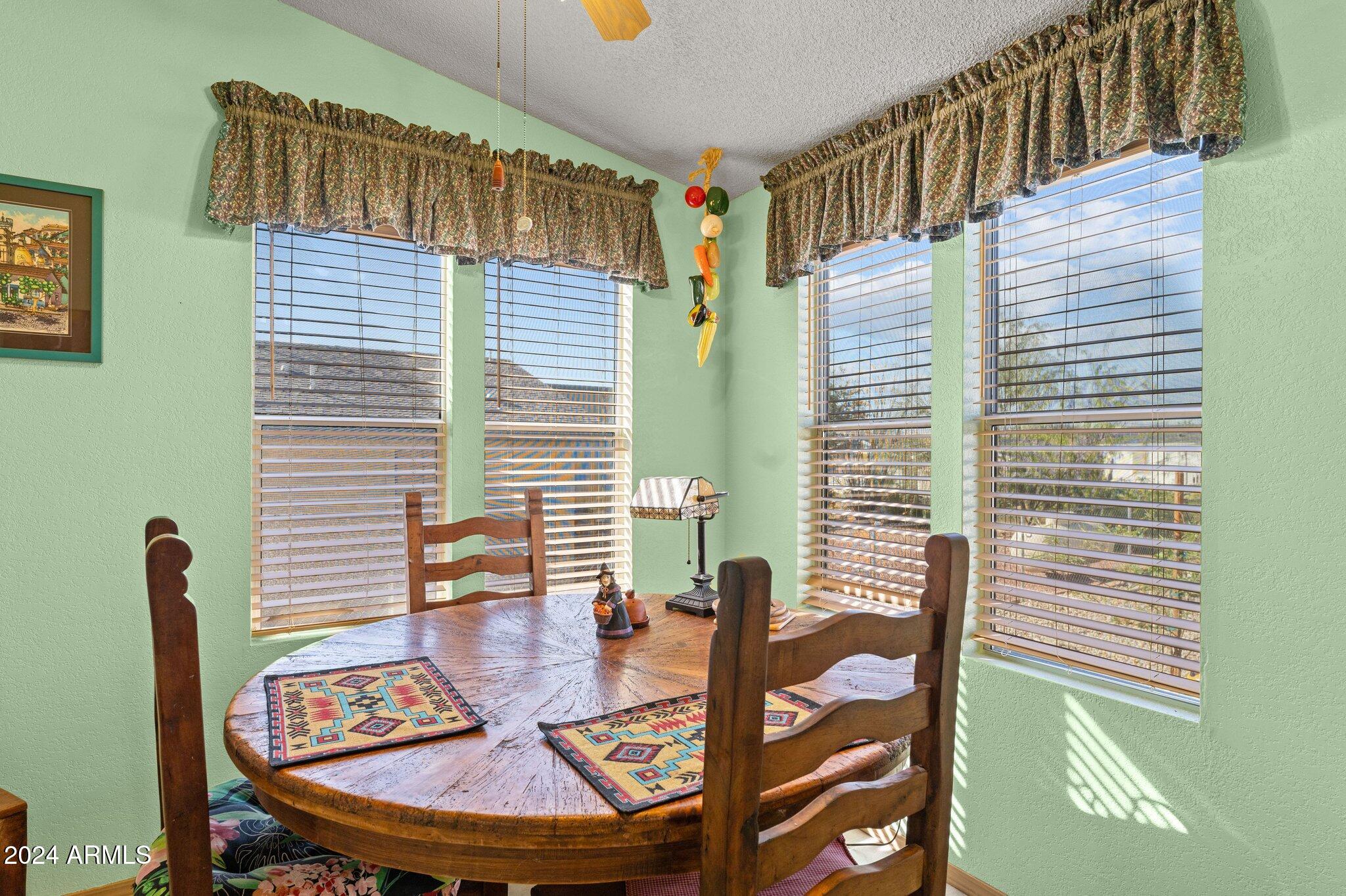 30854 Wandering Way Congress, AZ 85332 - Photo 21 of 43 a view of a dining room with furniture and wooden floor