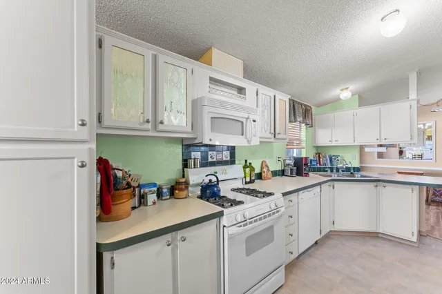 a kitchen with stainless steel appliances granite countertop a sink and cabinets