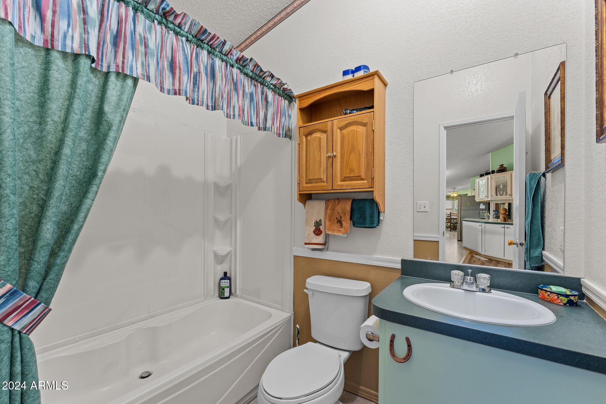 30854 Wandering Way Congress, AZ 85332 - Photo 25 of 43 a bathroom with a sink a toilet and a bathtub