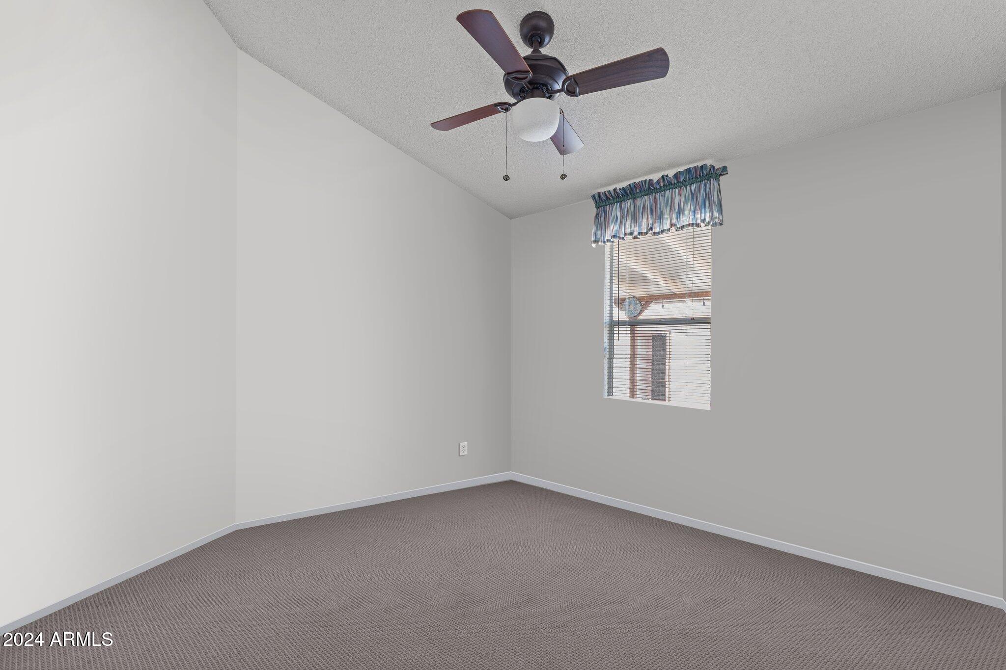 30854 Wandering Way Congress, AZ 85332 - Photo 26 of 43 an empty room with a window