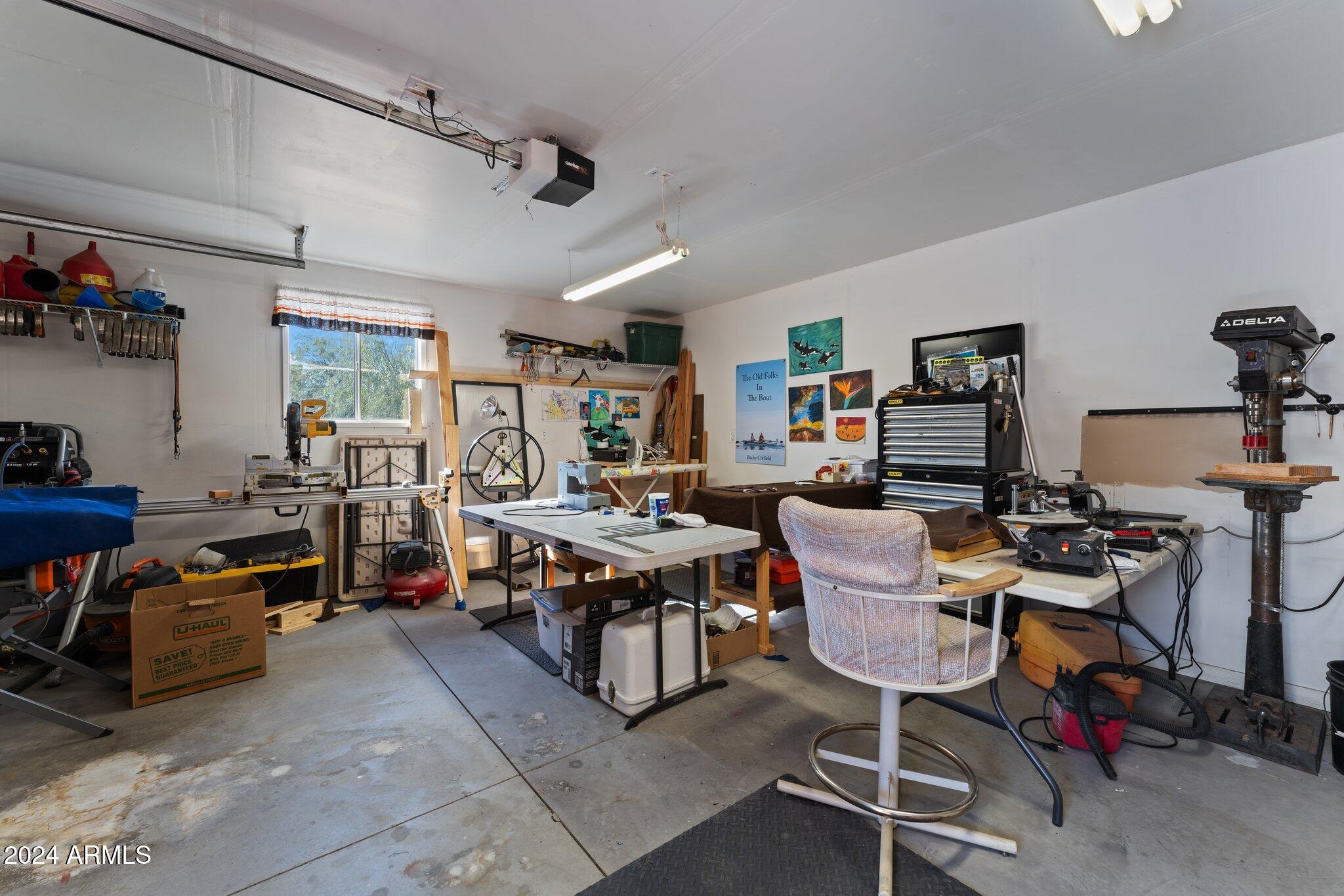 30854 Wandering Way Congress, AZ 85332 - Photo 30 of 43 a living room with lots of furniture and gym equipment