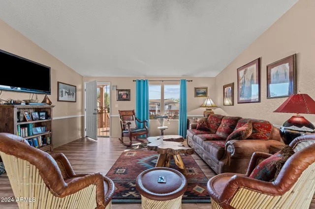 a living room with furniture a flat screen tv and rug floor