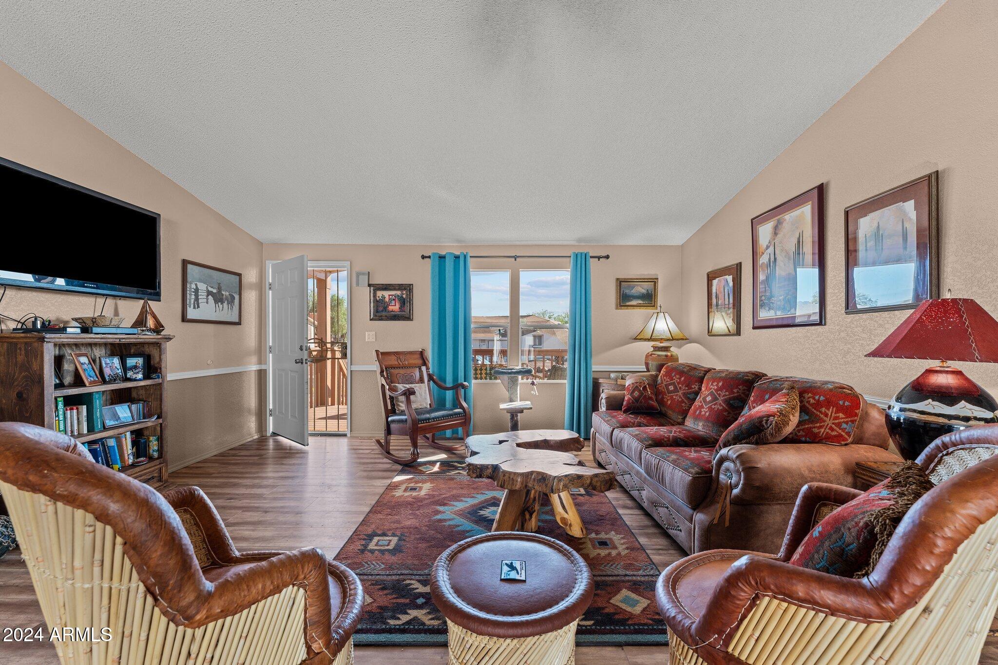 30854 Wandering Way Congress, AZ 85332 - Photo 8 of 43 a living room with furniture a flat screen tv and rug floor