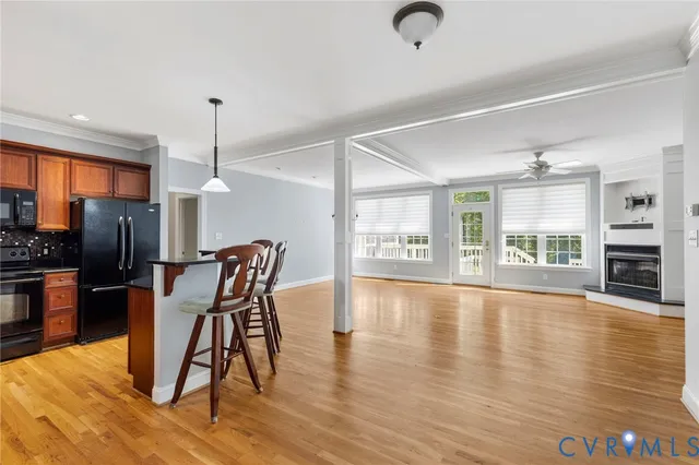 a view of a livingroom with furniture a chandelier and wooden floor
