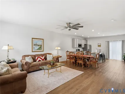 a living room with furniture kitchen view and a dining table