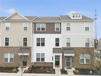 a front view of a residential apartment building with a yard