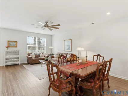 a view of a dining room with furniture and a large window