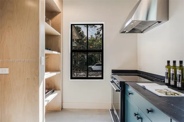 a view of a hallway with wooden floor and a chandelier
