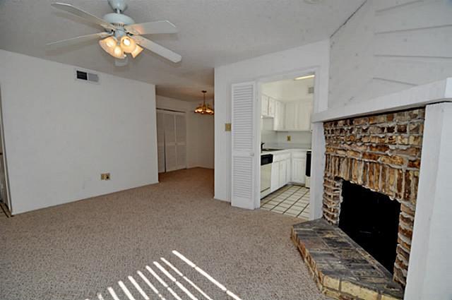 5630 Spring Valley Road, Unit 18C Dallas, TX 75254 - Photo 15 of 20 a living room with furniture and a fireplace