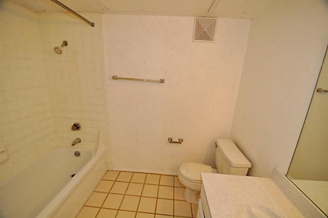 5630 Spring Valley Road, Unit 18C Dallas, TX 75254 - Photo 10 of 20 a bathroom with a sink and toilet