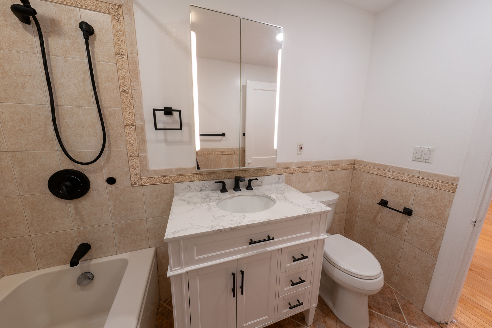 1460 West Foster Avenue, Unit 1 Chicago, IL 60640 - Photo 11 of 14 a bathroom with a sink a toilet and shower
