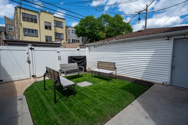a view of a backyard with plants and a patio