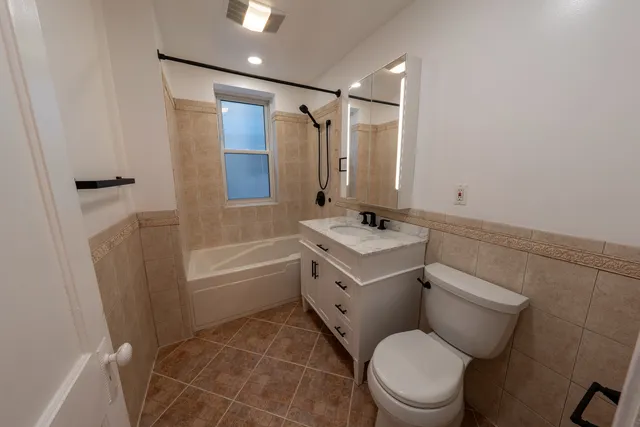 a bathroom with a sink toilet vanity and shower