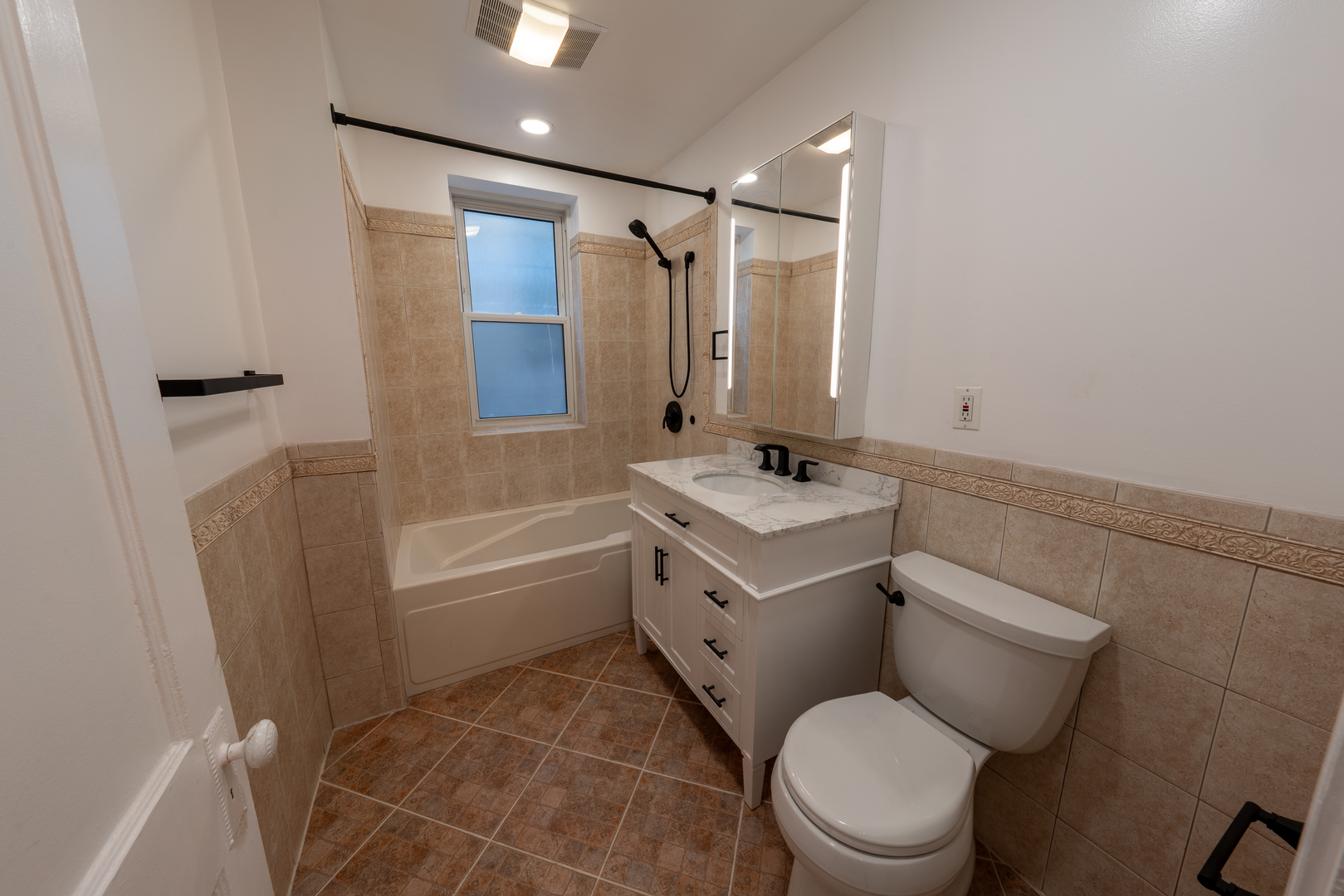 1460 West Foster Avenue, Unit 1 Chicago, IL 60640 - Photo 10 of 14 a bathroom with a sink toilet vanity and shower