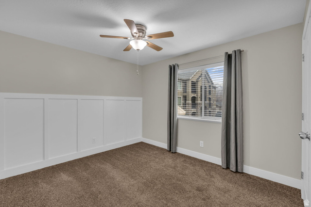 905 South Main Street, Unit G Layton, UT 84041 - Photo 12 of 36 Spare room featuring dark carpet and ceiling fan