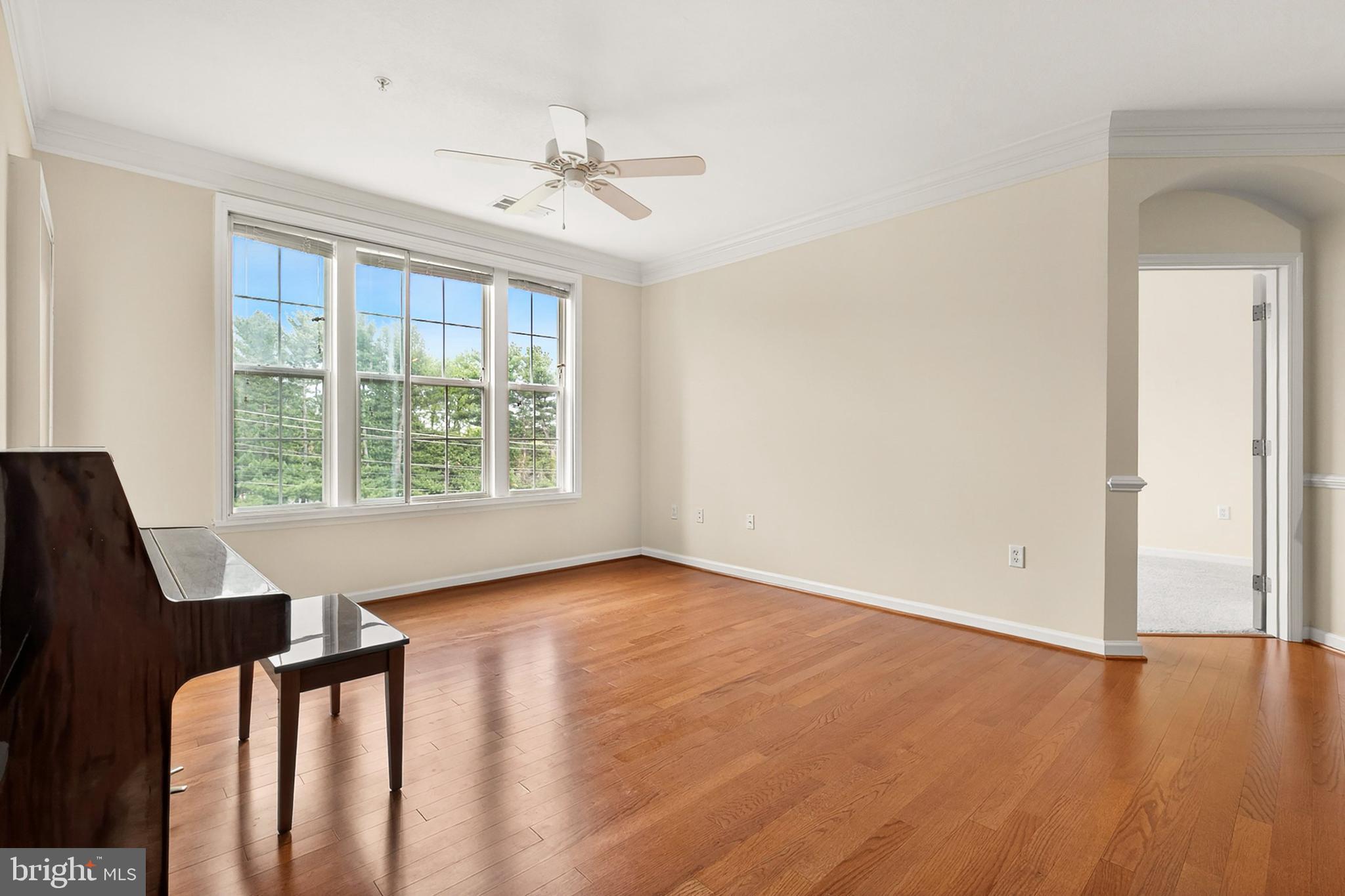 7 Granite Place, Unit 316 Gaithersburg, MD 20878 - Photo 15 of 84 an empty room with wooden floor fan and windows