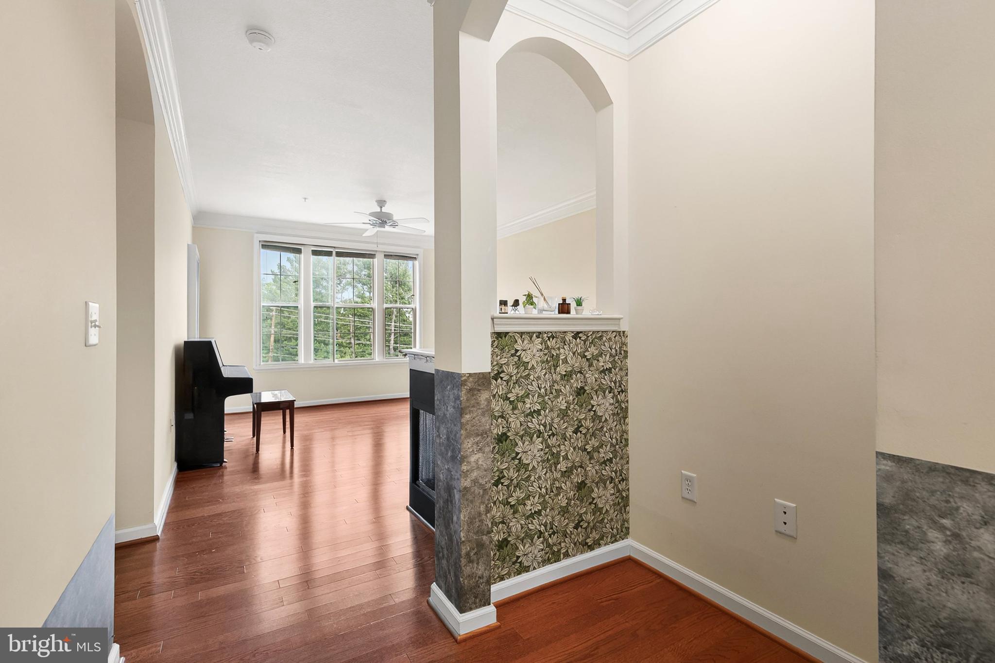 7 Granite Place, Unit 316 Gaithersburg, MD 20878 - Photo 4 of 84 an empty room with wooden floor and a window